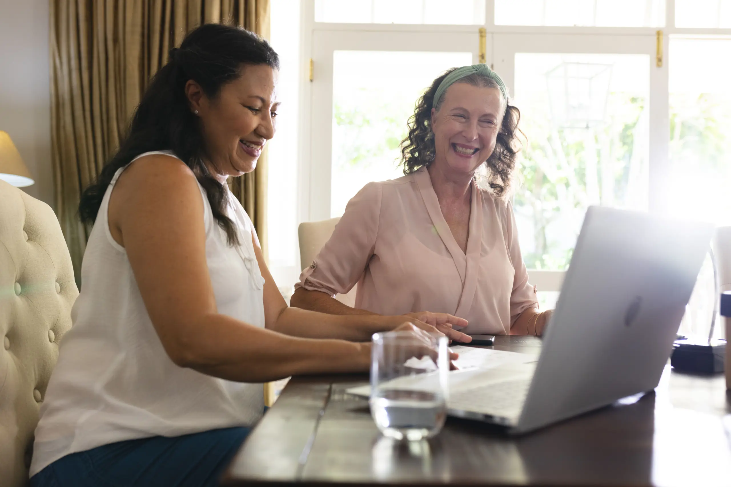 senior women smiling while using laptop at home e 2026 01 11 10 57 40 utc copy